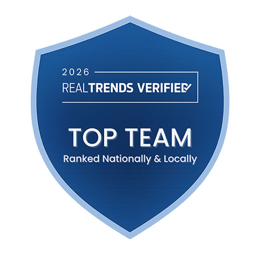 Blue shield-shaped badge displaying text: "2026 RealTrends Verified," "Top Team," and "Ranked Nationally & Locally".